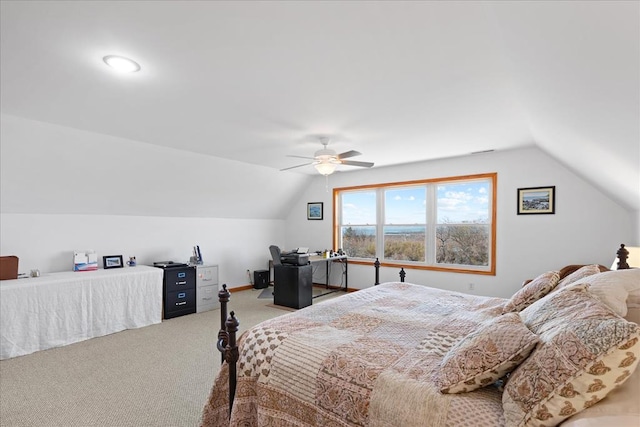 carpeted bedroom featuring baseboards, a ceiling fan, and vaulted ceiling