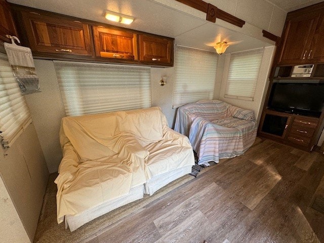 bedroom with dark wood-type flooring