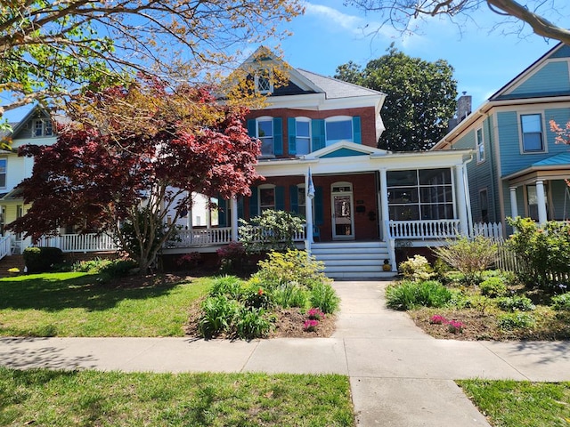 view of front of home featuring covered porch and a front yard