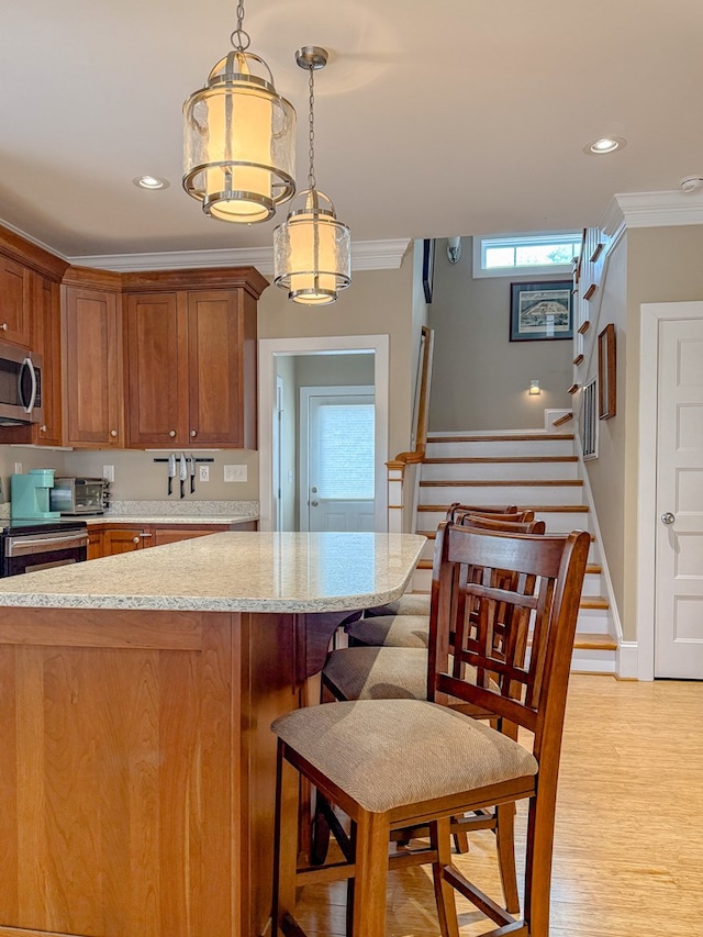 510 Plum St, Cape Charles, VA 23310 - kitchen with ornamental molding, brown cabinetry, light stone countertops, and stainless steel appliances