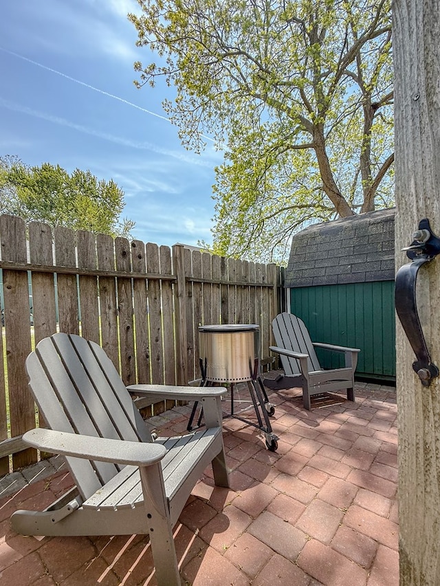 510 Plum St, Cape Charles, VA 23310 - view of patio featuring a storage unit, fence, and an outdoor structure