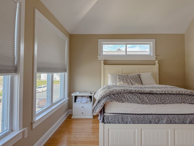 510 Plum St, Cape Charles, VA 23310 - bedroom featuring lofted ceiling, baseboards, light wood-style flooring, and multiple windows