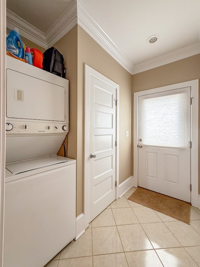 510 Plum St, Cape Charles, VA 23310 - laundry area with light tile patterned floors, stacked washer / dryer, crown molding, baseboards, and laundry area
