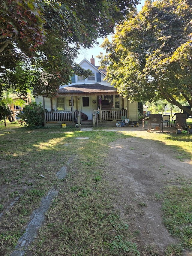 view of front of property with a porch and a front yard