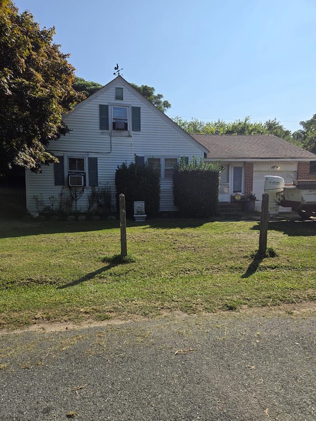 view of front of home featuring a garage and a front lawn