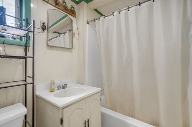 bathroom with shower / tub combo, vanity, and toilet