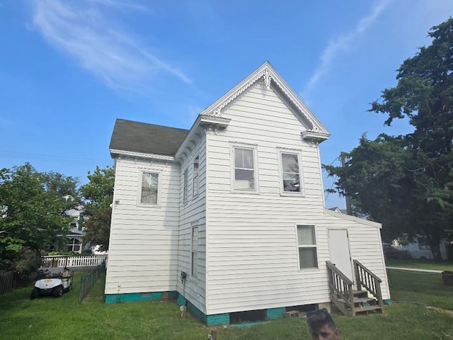 view of side of home featuring a lawn