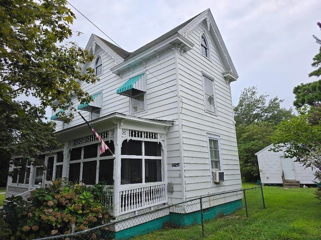 view of property exterior featuring a lawn and cooling unit