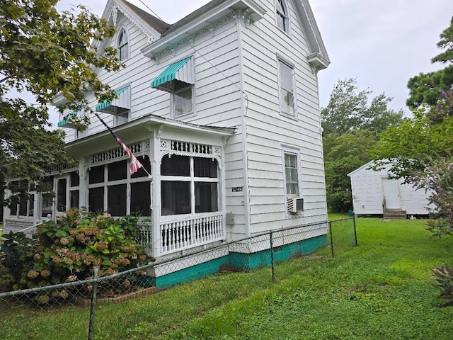 view of side of home with a lawn and cooling unit