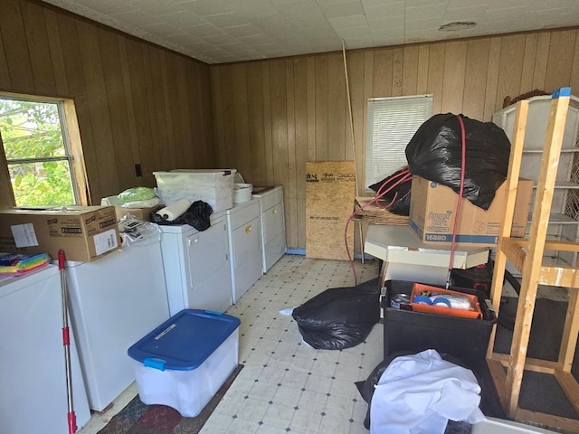 washroom featuring separate washer and dryer and wooden walls