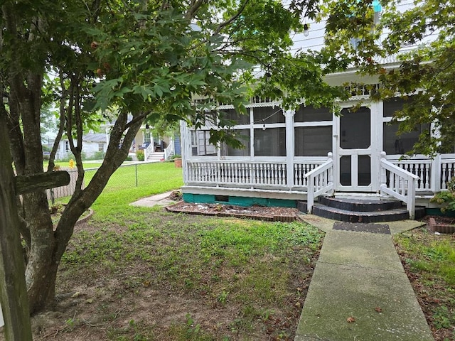 exterior space featuring a sunroom and a yard