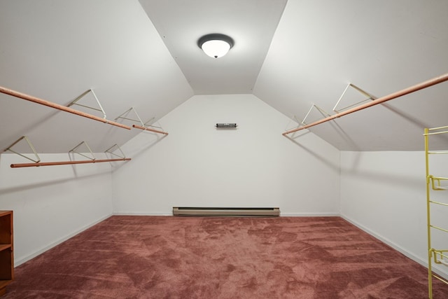 walk in closet with a baseboard radiator, carpet, and lofted ceiling