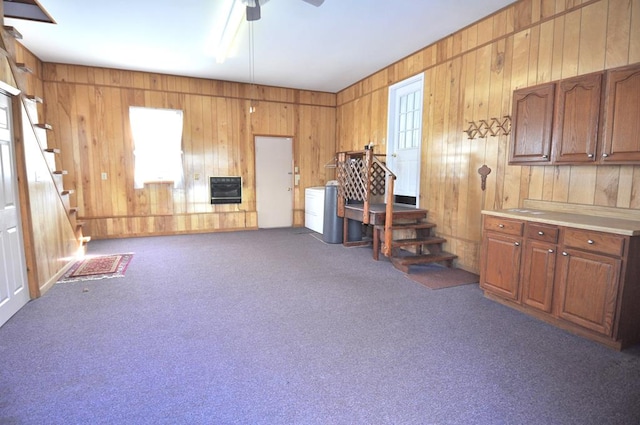 misc room with ceiling fan, dark carpet, and heating unit