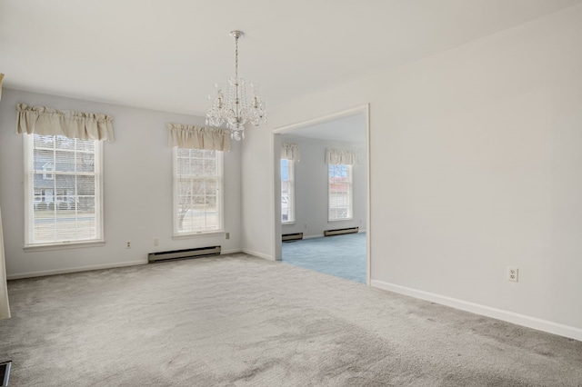 carpeted spare room with plenty of natural light, a baseboard heating unit, and a notable chandelier