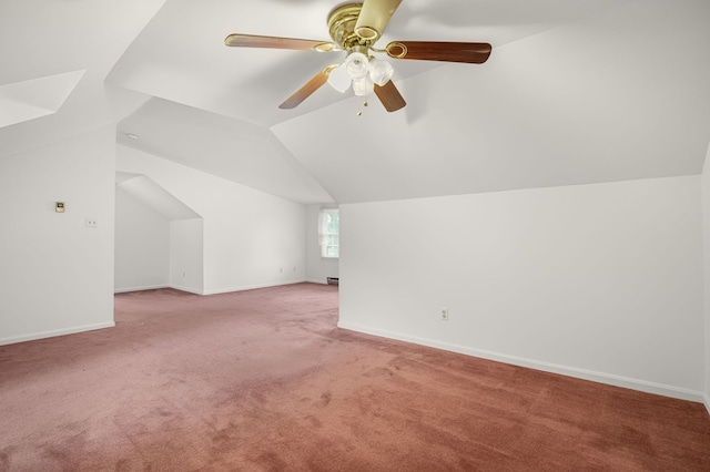 bonus room with ceiling fan, vaulted ceiling, and light carpet