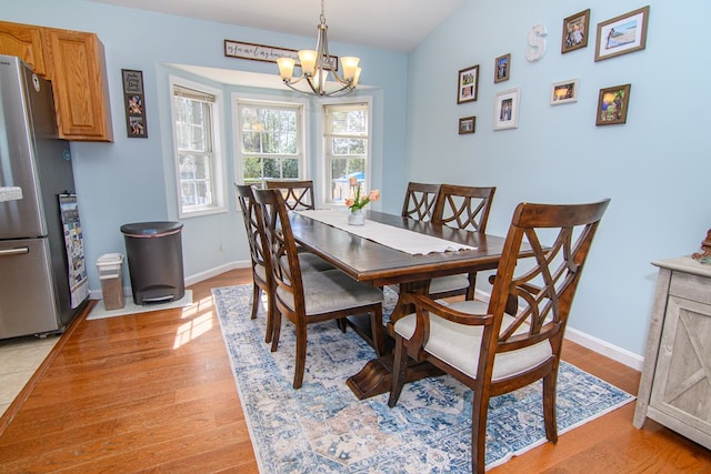 6545 Occohannock Neck Rd, Exmore, VA 23350 - dining space with baseboards, light wood finished floors, and a chandelier