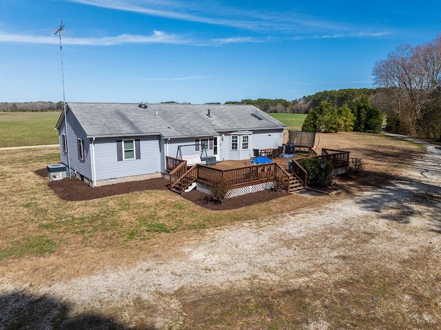 6545 Occohannock Neck Rd, Exmore, VA 23350 - rear view of house featuring a wooden deck, a lawn, cooling unit, and a shingled roof