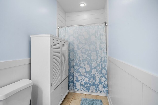 bathroom featuring tile patterned flooring and toilet