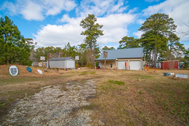 view of front of home with a garage and an outdoor structure