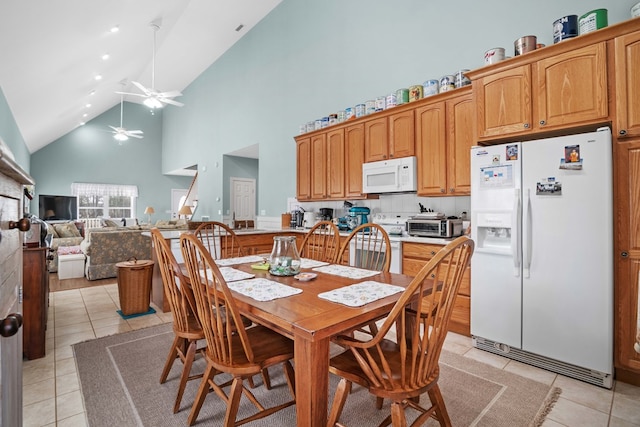 dining area with high vaulted ceiling, ceiling fan, and light tile patterned flooring