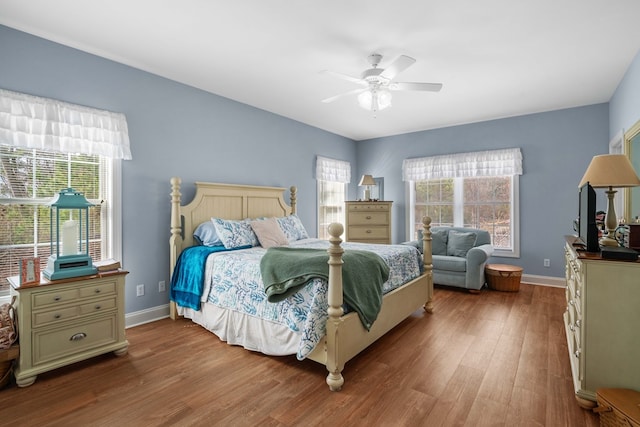 bedroom with ceiling fan and hardwood / wood-style flooring