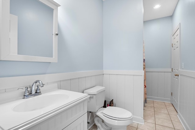 bathroom with tile patterned floors, vanity, and toilet