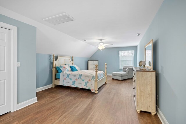 bedroom featuring hardwood / wood-style floors, ceiling fan, and lofted ceiling