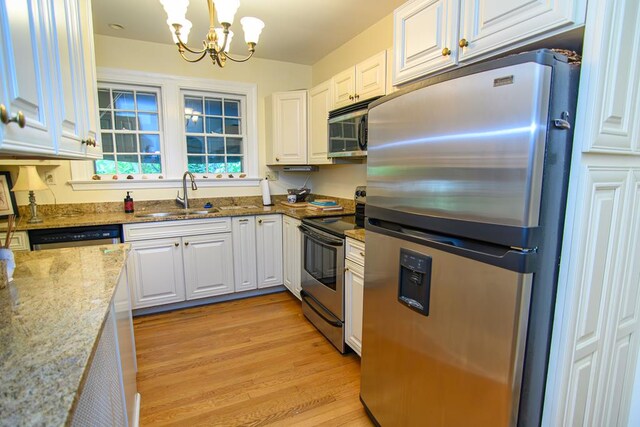 86 Market St, Onancock, VA 23417 - kitchen with stainless steel appliances, a sink, and white cabinetry