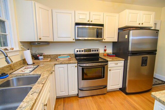 86 Market St, Onancock, VA 23417 - kitchen featuring appliances with stainless steel finishes, a sink, and white cabinets