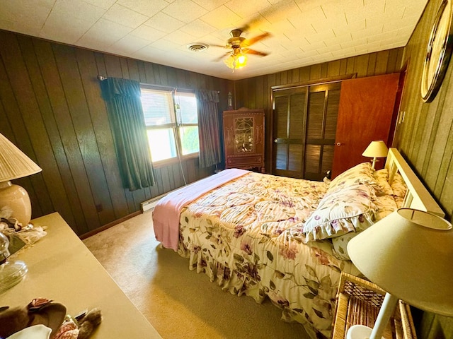 3434 Willow St, Chincoteague, VA 23336 - bedroom with wood walls, carpet, a closet, and a ceiling fan