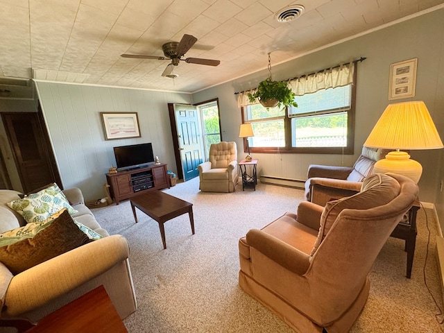 3434 Willow St, Chincoteague, VA 23336 - living area featuring baseboard heating, carpet floors, ornamental molding, ceiling fan, and wooden walls