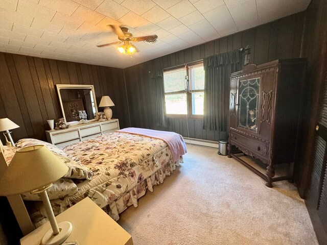 3434 Willow St, Chincoteague, VA 23336 - bedroom with light carpet, a baseboard radiator, wood walls, and ceiling fan