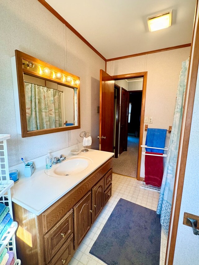 3434 Willow St, Chincoteague, VA 23336 - bathroom with ornamental molding, tile patterned floors, and vanity