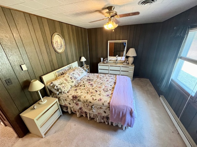 3434 Willow St, Chincoteague, VA 23336 - bedroom featuring a baseboard heating unit, wood walls, carpet, and ceiling fan