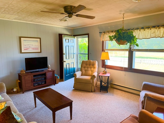 3434 Willow St, Chincoteague, VA 23336 - living area featuring baseboard heating, a ceiling fan, carpet flooring, ornamental molding, and wood walls