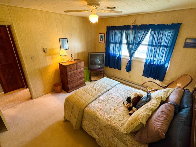 3434 Willow St, Chincoteague, VA 23336 - bedroom with carpet, a baseboard radiator, wood walls, and ceiling fan