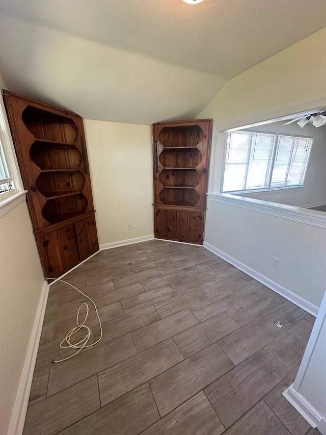 foyer featuring baseboards, a ceiling fan, wood finished floors, and vaulted ceiling
