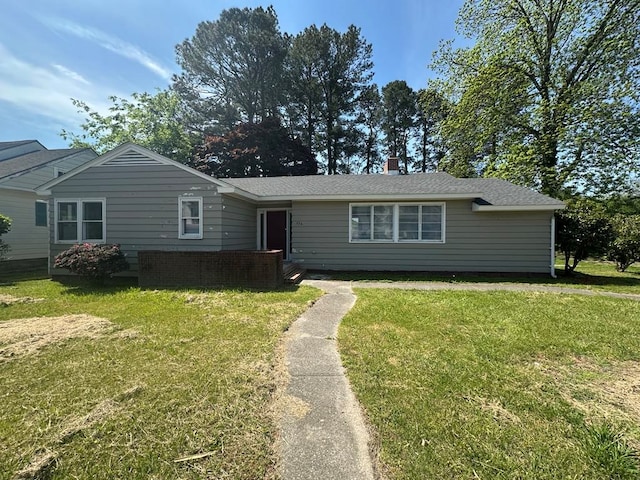 single story home featuring a front lawn and a chimney