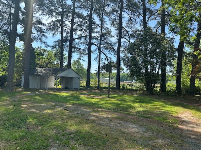 view of yard with a shed, an outdoor structure, and a carport