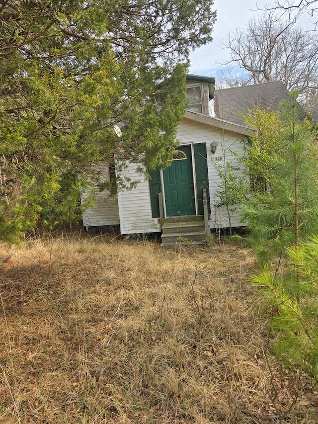 rear view of property featuring entry steps