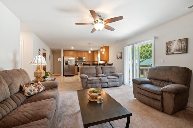 carpeted living room with ceiling fan