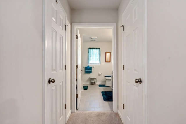 hall with light tile patterned floors