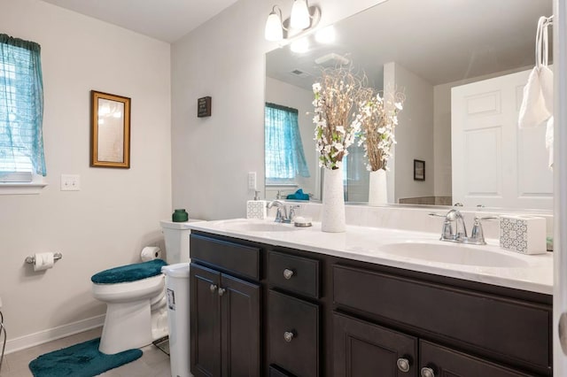 bathroom with tile patterned flooring, vanity, and toilet