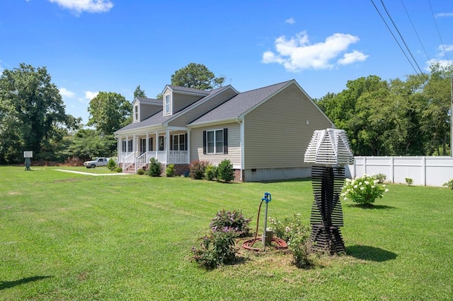 view of home's exterior with covered porch and a yard