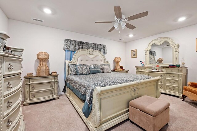 bedroom featuring light colored carpet and ceiling fan