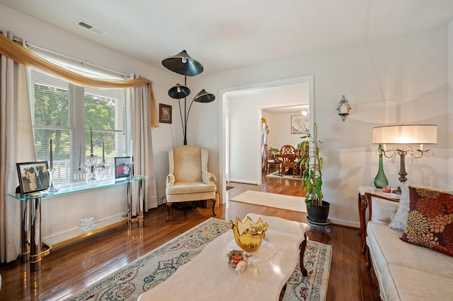 sitting room with dark wood-type flooring