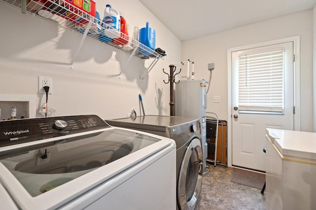 washroom with washer and clothes dryer and water heater