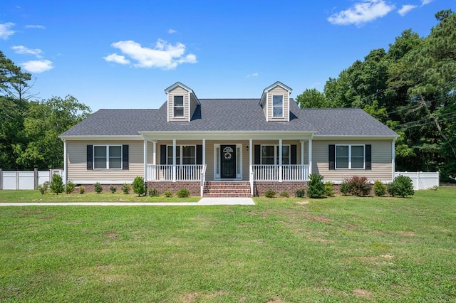 cape cod home featuring covered porch and a front yard