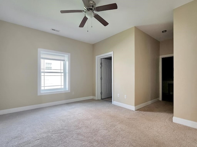 carpeted spare room with ceiling fan