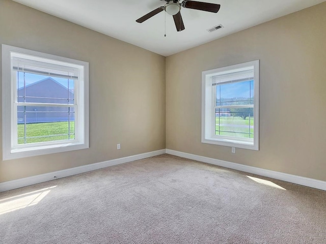 carpeted empty room featuring ceiling fan